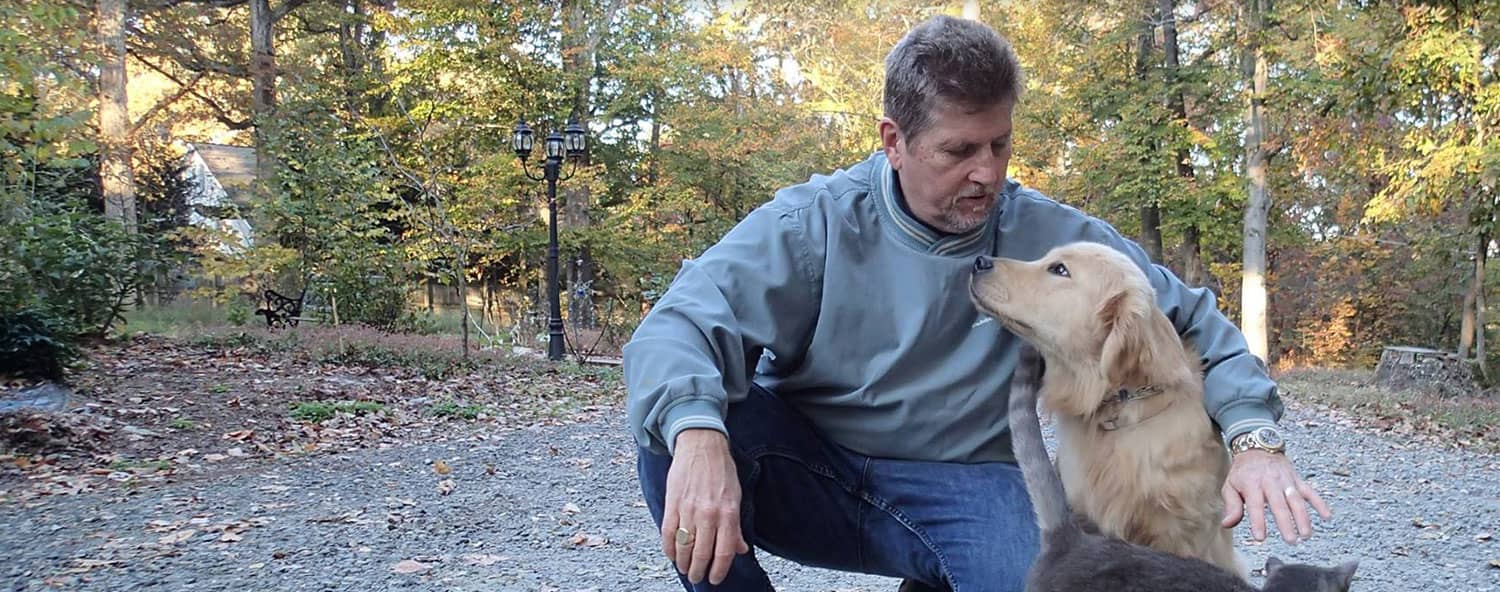 Jim Hodges with a golden retriever